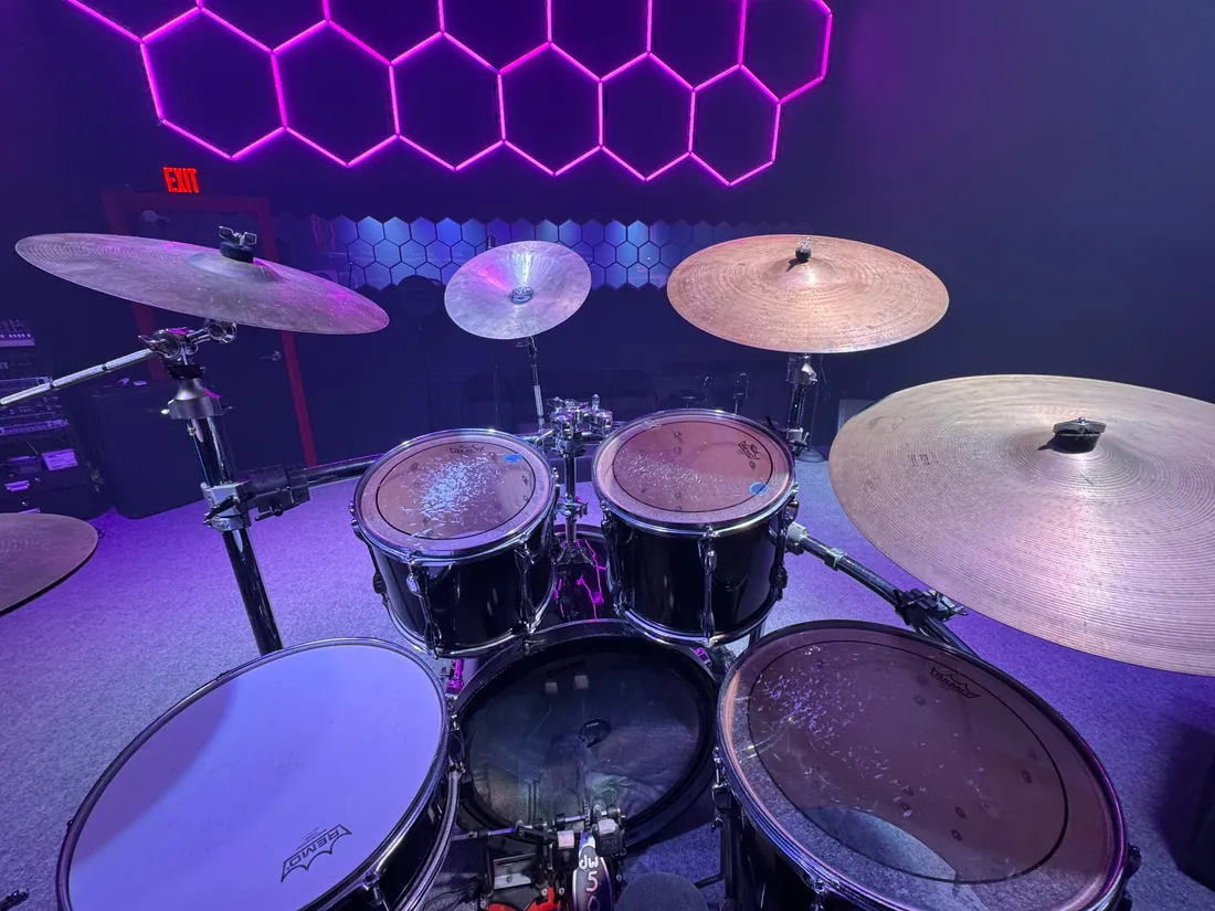Drum kit under purple hexagon lighting at VIP Studios