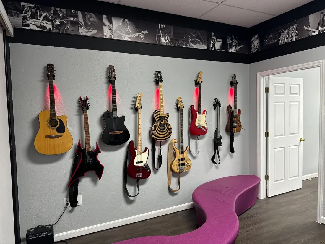 Wall of acoustic, electric and bass guitars at VIP Studios
